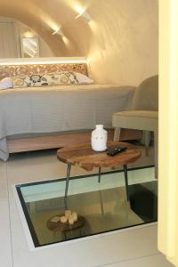 a room with a bed and a table with a table at Esperia Luxury Suites in Astypalaia Town