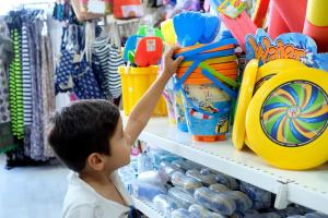 a young boy is shopping in a store at Paradise Bay Resort in Mellieħa