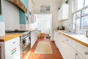 a kitchen with white cabinets and a stove top oven at 3 Claremont Terrace in York