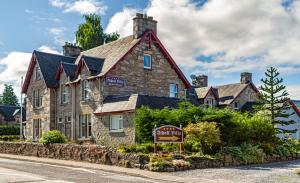 a large stone building with a sign in front of it at Atholl Villa Guest House in Pitlochry