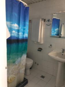 ein Bad mit einem Waschbecken, einem WC und einer Dusche in der Unterkunft Mistral-Καπος in Erateini