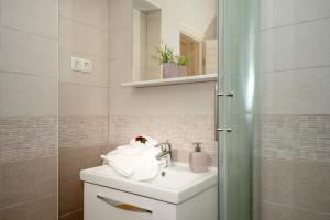 a bathroom with a white sink and a mirror at Villa Vista Hvar in Jelsa +67 photos