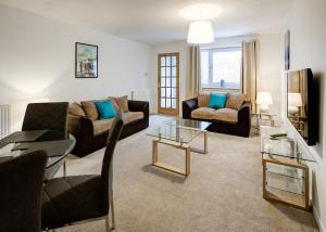 a living room with a couch and a table at Struan House in Inverkeithing