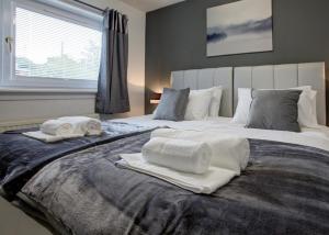 een slaapkamer met een bed met handdoeken erop bij Struan House in Inverkeithing