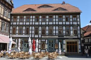 a large building with tables and chairs in front of it at Maisonette am Markt - Schlossblick - WLAN+Netflix in Wernigerode