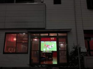 a video game on a television in a window at HappyCloset&WasamonHostel in Kumamoto