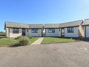 a house with a driveway in front of it at Surfside in Marazion