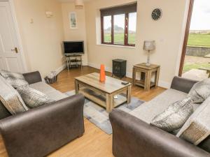 a living room with two couches and a coffee table at Shoreline in Marazion