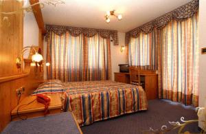 Postel nebo postele na pokoji v ubytování Family & Wellness Hotel Fontana