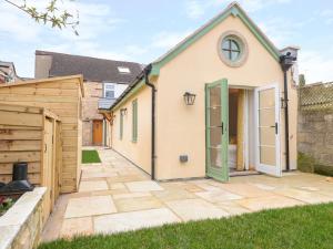 a detached house with a garden and a patio at Old Sorting Office in Cheltenham