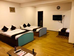 Postel nebo postele na pokoji v ubytování Hotel Satyam