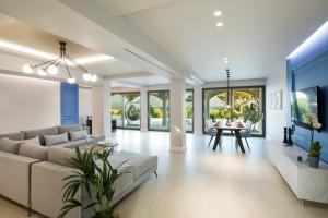 a living room with a couch and a table at Villa Onore in Dassia
