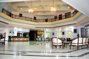 a large room with chairs and a table in it at The Royal Residency in Bodh Gaya