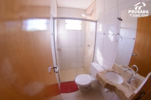 a bathroom with a shower and a toilet and a sink at Pousada do Gui-Gui Aeroporto in Goiânia