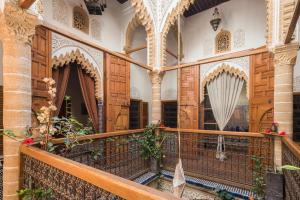 a balcony in a building with wooden doors at Riad Marhaba in Rabat