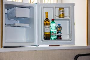 an open refrigerator filled with bottles of alcohol at Old Tbilisi apartments in Tbilisi City