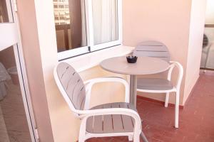 a table and chairs in a room with a window at MS Amaragua in Torremolinos