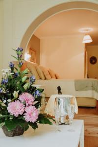 a vase of flowers sits on a table in a hotel room at Cashel House Hotel in Roundstone