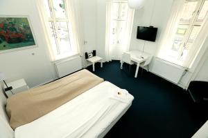Postel nebo postele na pokoji v ubytování Hotel 9 små hjem
