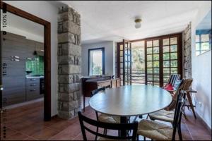 a kitchen and dining room with a table and chairs at Casa Sulky SantAntioco in Maladroscia