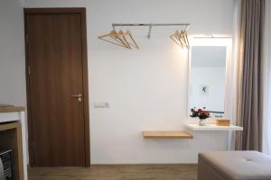a living room with a door and a mirror at Twins in Tbilisi City