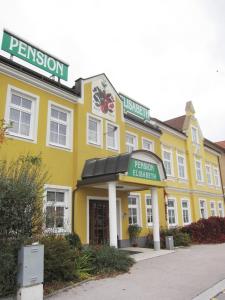 a yellow building with a sign that reads pension library at Pension Elisabeth in Sankt Pölten