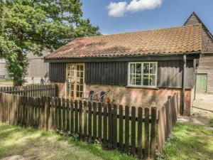 an old house with a fence in front of it at The Bull Pen in Eye