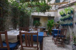 a table and chairs with wine glasses on it at Locanda Guelfo in Tredozio