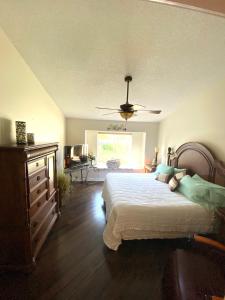 a bedroom with a bed and a ceiling fan at Modern Pool Home in Spring Hill