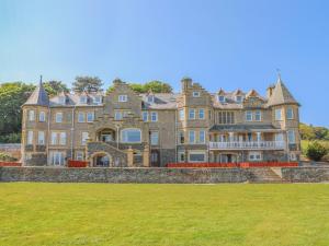 a large house with a grass field in front of it at Nyth y Fran in Menai Bridge