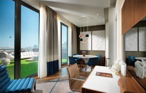 a living room with a table and chairs and a large window at Sheraton Baku Intourist in Baku