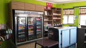 a store with two refrigerators in a grocery store at Hotel Ibirapuera in Barretos