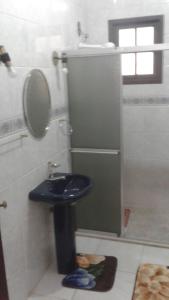 a bathroom with a blue toilet and a sink at Central 1 in Uruguaiana