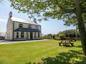 a house with a picnic table in front of it at Glyn Ewryd in Bodewryd