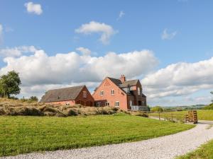 an old house on a hill with a grass field at Highcroft in Belper