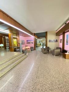 a lobby of a hospital with couches and chairs at Hotel Pamela in San Pietro in Casale