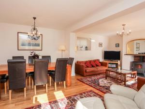 a living room with a table and a couch at Cae Gallt in Menai Bridge