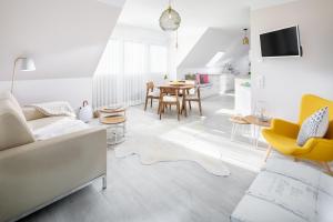 a living room with a couch and a table at Sandkasten 6 in Norddeich