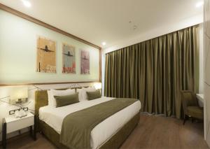 
a bedroom with a large bed and a large window at ISG Sabiha Gökçen Airport Hotel in Istanbul
