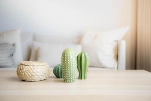 two green cactuses on a table in a living room at Sandbox Beachfront Villa 3 in Ban Krathing Lai +19 photos