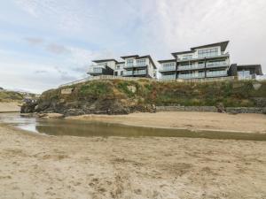 a house on top of a hill next to a beach at Chapel Rock View, The Dunes in Perranporth