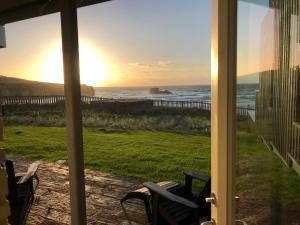 a view of the ocean from the porch of a house at Chapel Rock View, The Dunes in Perranporth