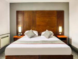 a bedroom with a large bed with two night stands at OYO Flagship Sheffield City Centre in Sheffield