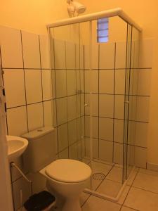 a bathroom with a shower with a toilet and a sink at Pousada Casa de Bragança II in Bragança Paulista