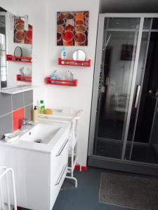 a bathroom with a sink and a shower at La Lézardière in La Rochefoucauld