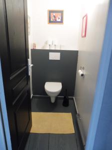 a small bathroom with a toilet and a sink at La Lézardière in La Rochefoucauld