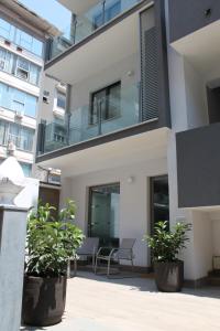 a building with two potted plants in front of it at Residence Pola in Catania