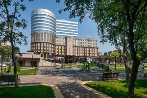 a large building with a playground in a park at Mercure Voronezh Center in Voronezh