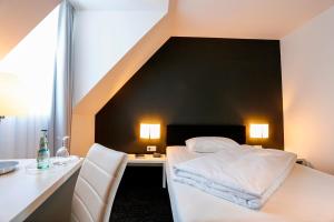 Postel nebo postele na pokoji v ubytování Hotel Schempp