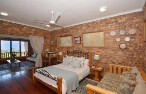 a bedroom with a bed and a brick wall at IRONWOOD LODGE in Pennington